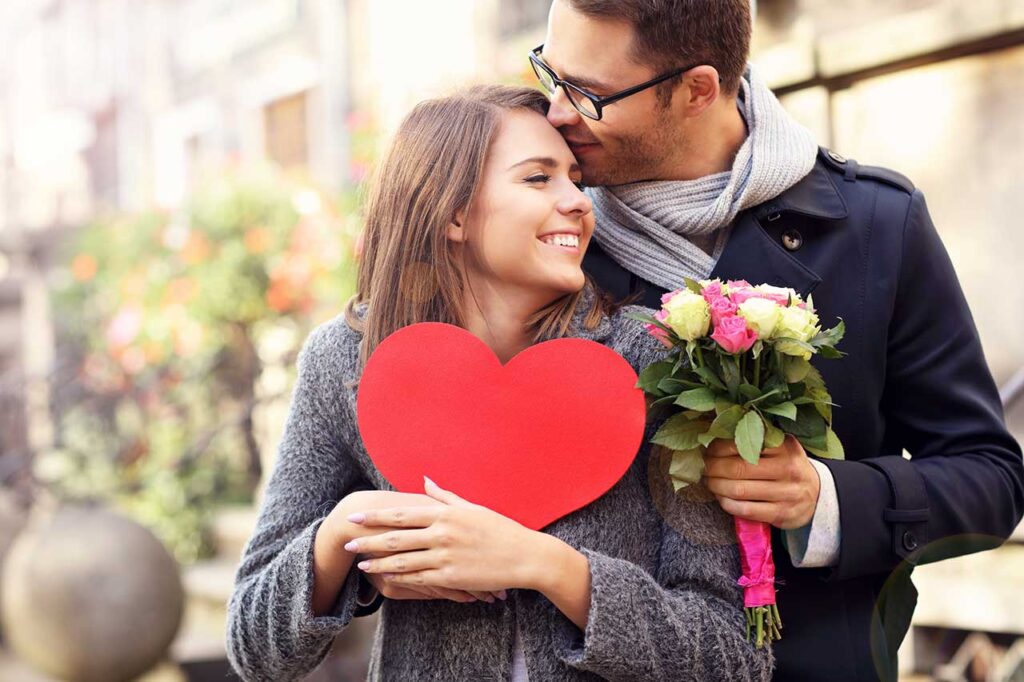 Couple posing with flowers and valentine's heart